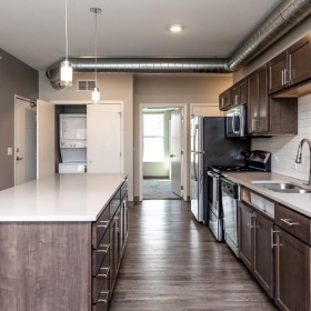 a kitchen with wooden cabinets
